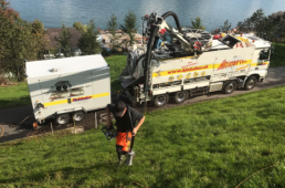 Water jetting truck in the Alps to jet the deposits from the line